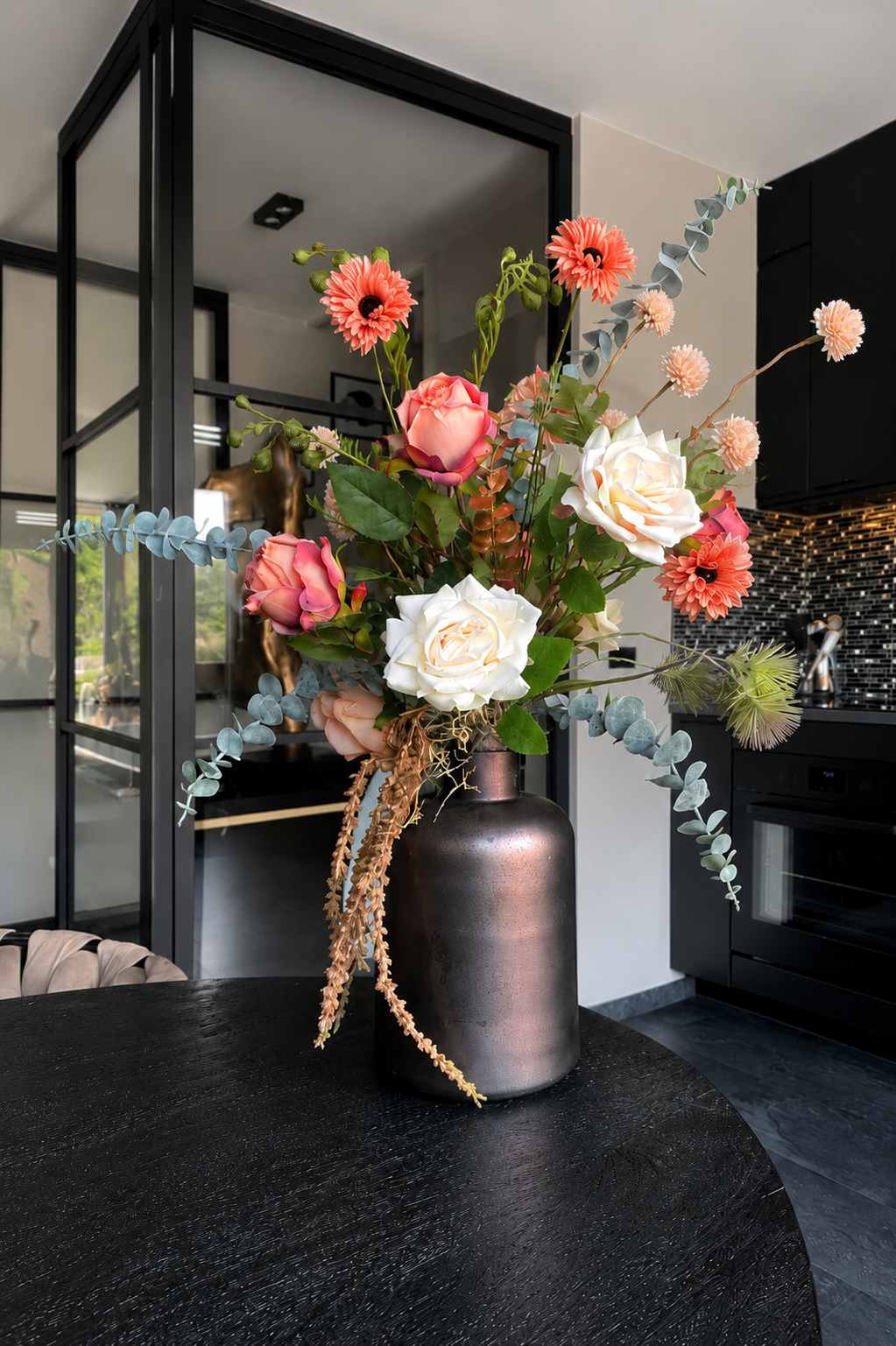 Luxe zijdebloemstuk met witte en roze rozen, zalmkleurige gerbera's en eucalyptus in bronzen vaas